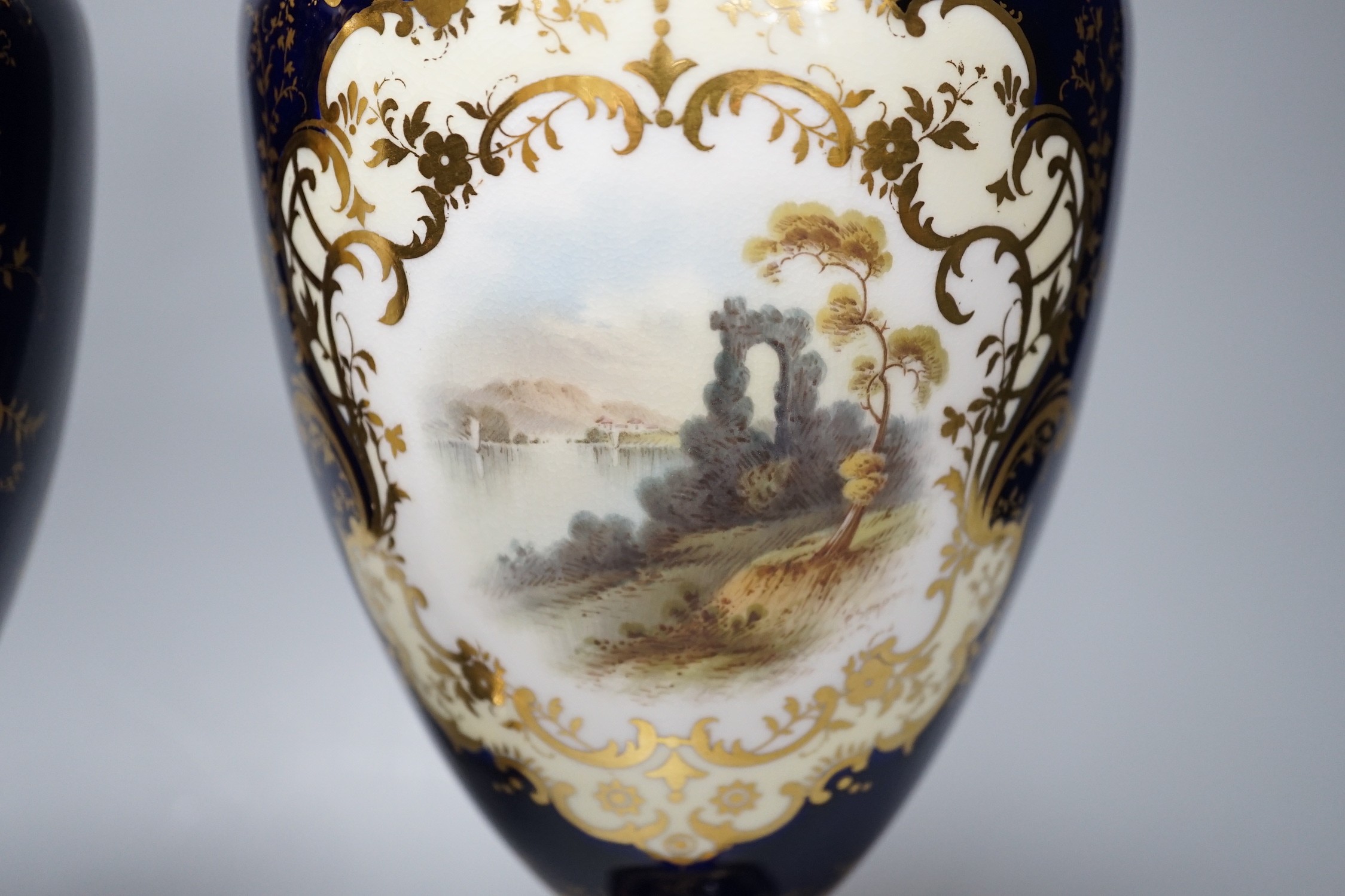 A pair of Coalport vases painted with Loch scenes by Percy Simpson, signed, 32cm